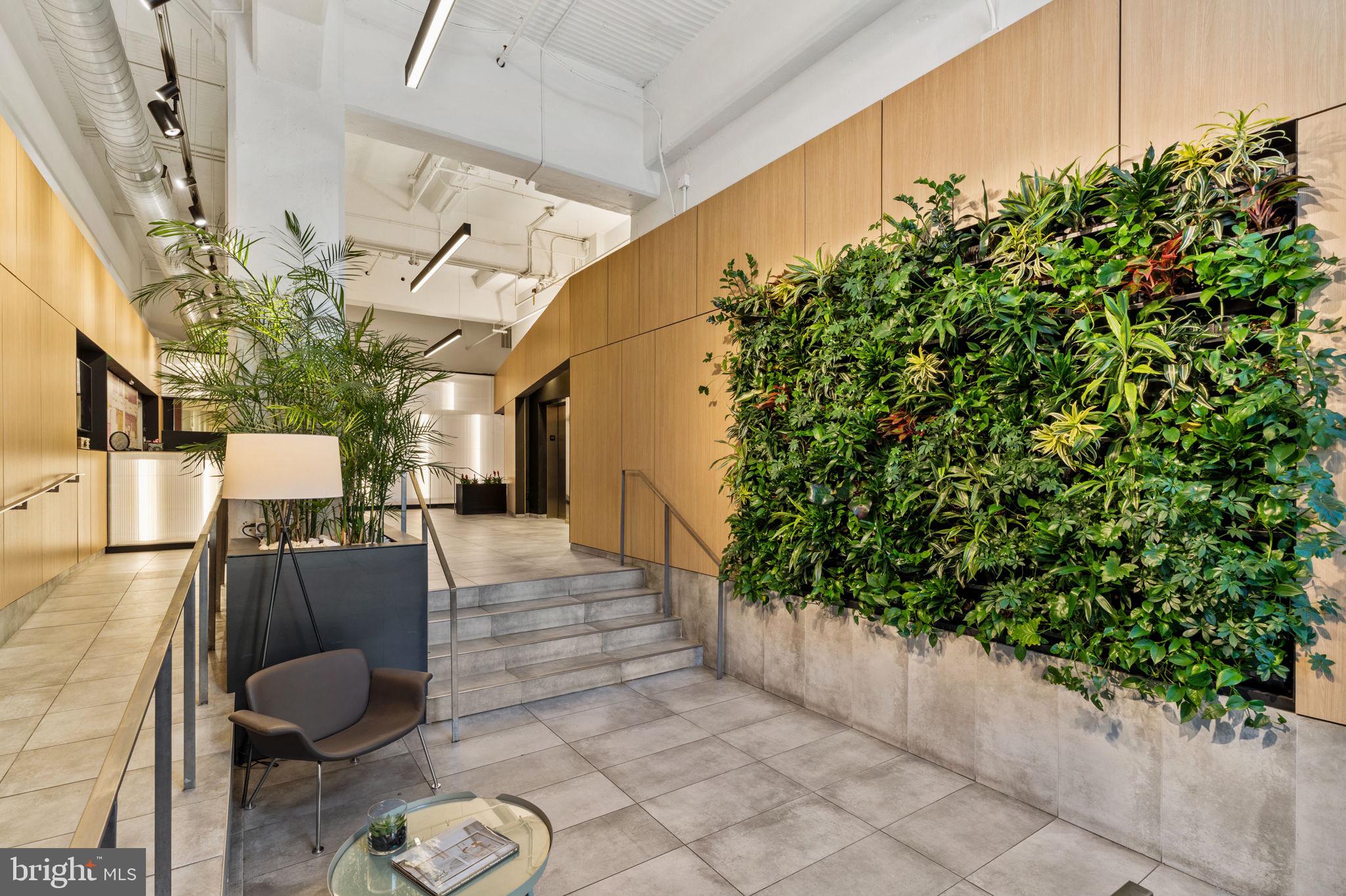 2200-28 Arch Street, Unit 1205 Philadelphia, PA 19103 - Photo 44 of 48 a living room with furniture and a potted plant