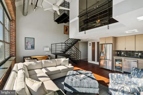 a living room with furniture and kitchen view
