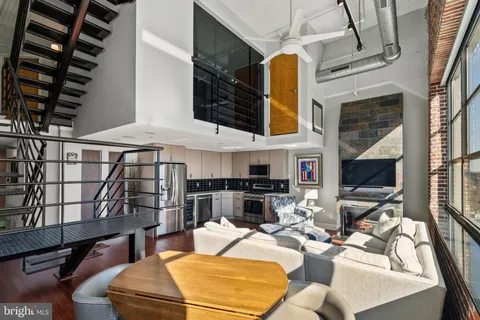 a living room with fireplace furniture and a flat screen tv