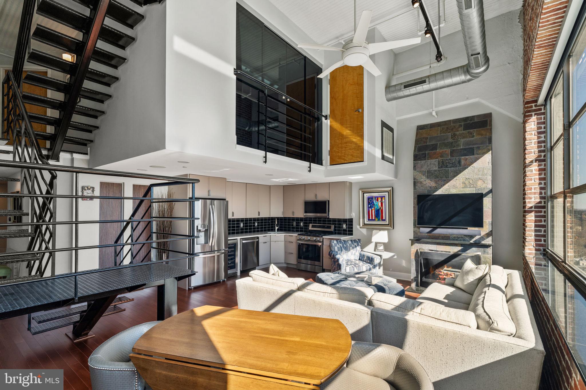 2200-28 Arch Street, Unit 1205 Philadelphia, PA 19103 - Photo 6 of 48 a living room with fireplace furniture and a flat screen tv