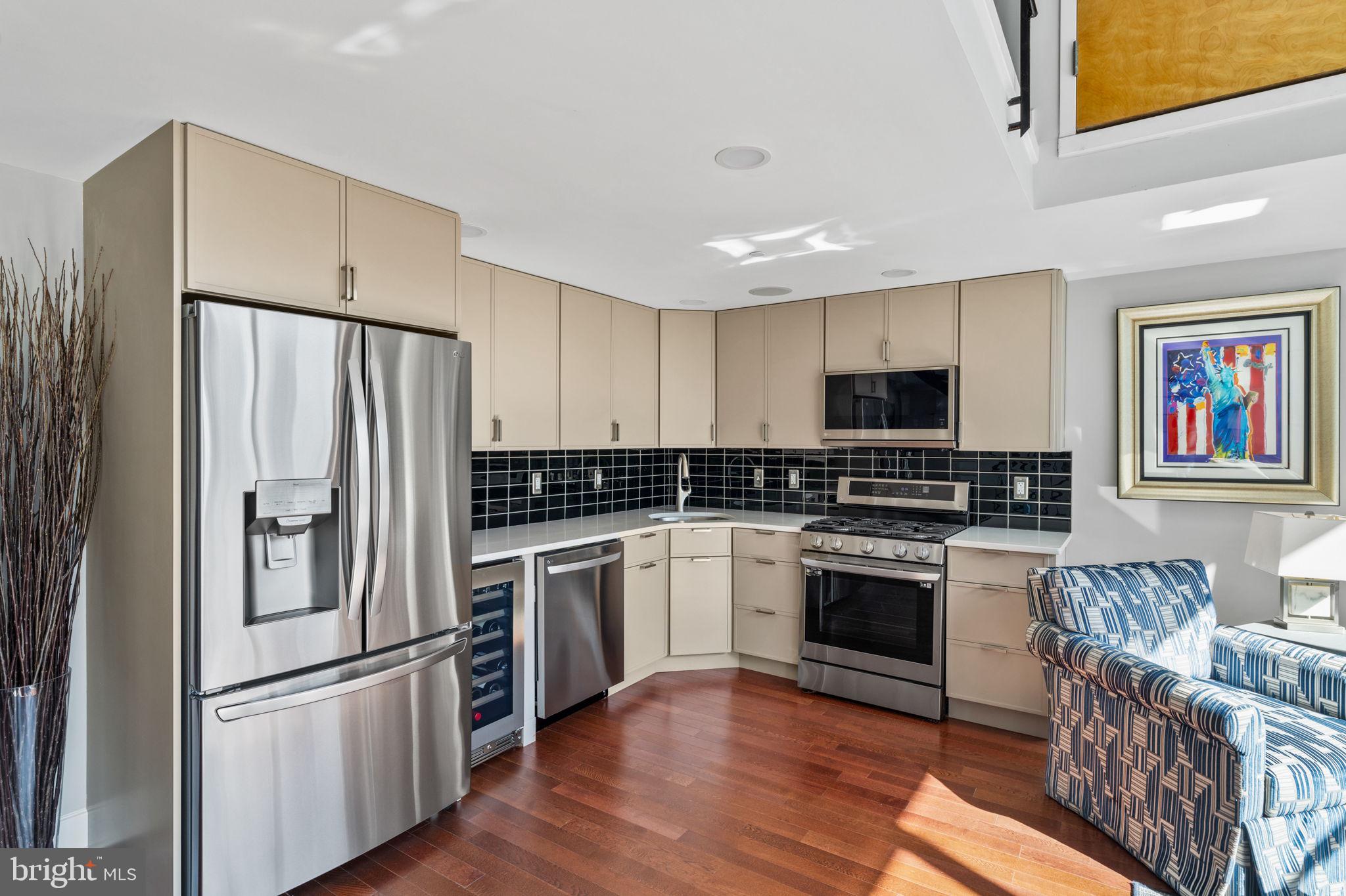 2200-28 Arch Street, Unit 1205 Philadelphia, PA 19103 - Photo 8 of 48 a kitchen with stainless steel appliances and wooden floor