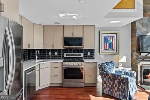 a kitchen with stainless steel appliances a stove a sink and a refrigerator