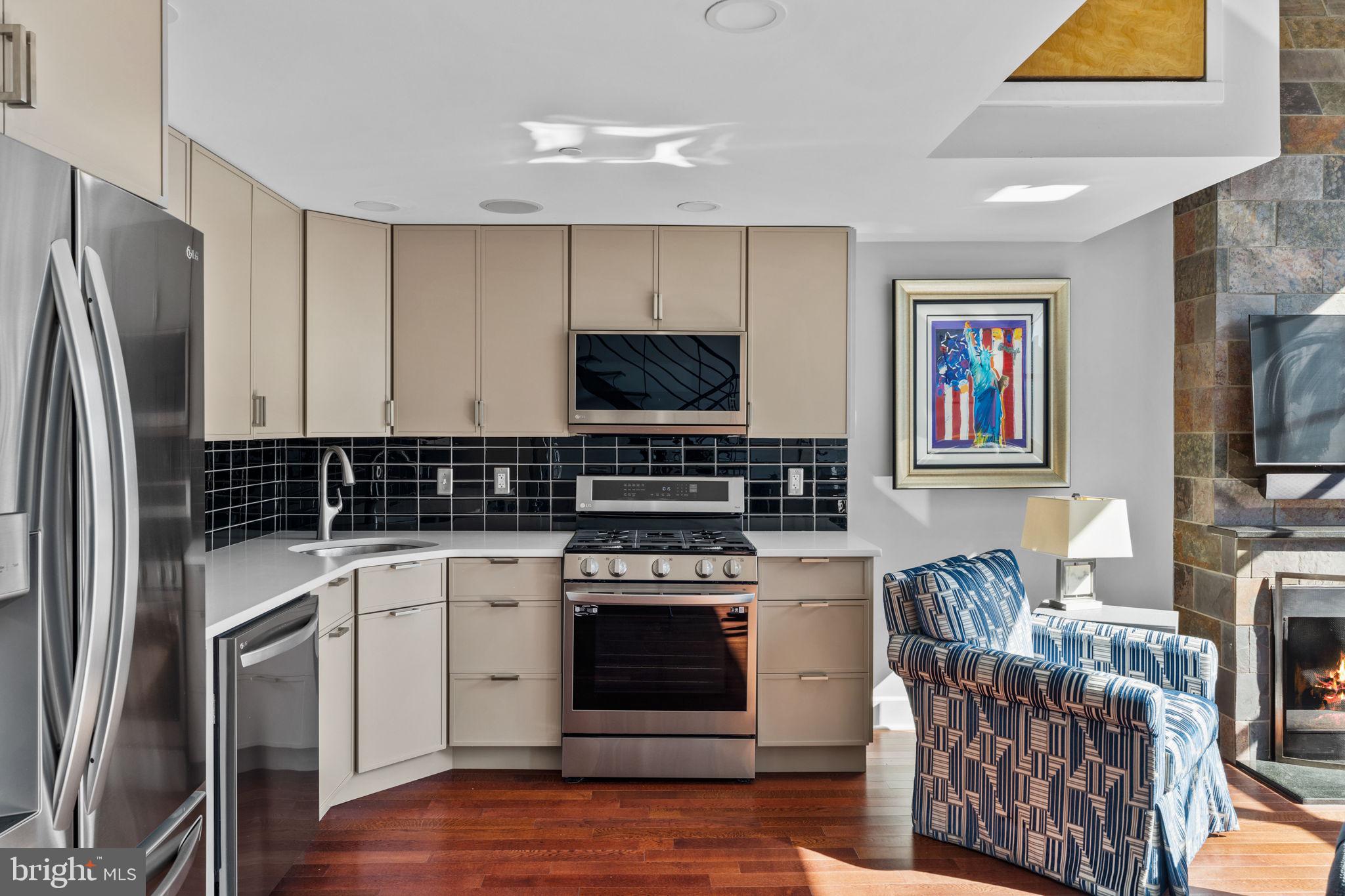 2200-28 Arch Street, Unit 1205 Philadelphia, PA 19103 - Photo 9 of 48 a kitchen with stainless steel appliances a stove a sink and a refrigerator