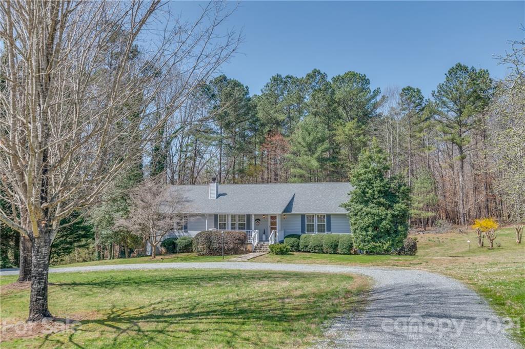569 Flynn Road Rutherfordton, NC 28139 - Photo 2 of 34 a view of a big house in a big yard with large trees