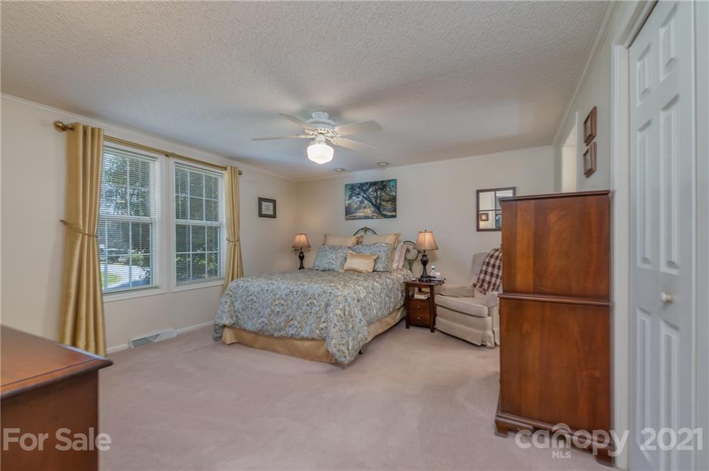 569 Flynn Road Rutherfordton, NC 28139 - Photo 17 of 34 a bedroom with a bed and a refrigerator