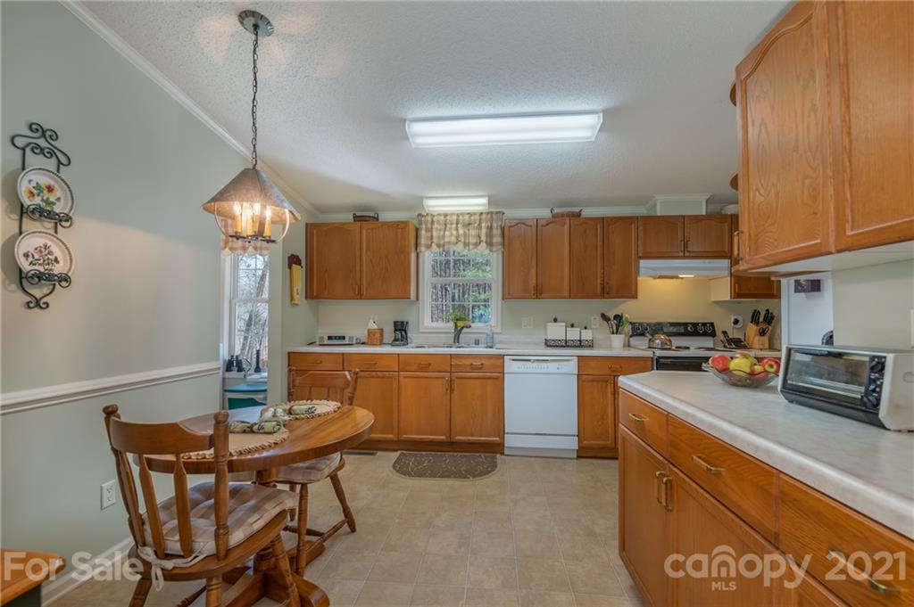 569 Flynn Road Rutherfordton, NC 28139 - Photo 20 of 34 a kitchen with a table chairs stove and cabinets
