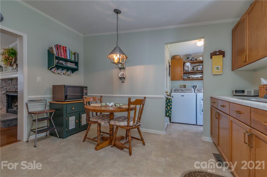 569 Flynn Road Rutherfordton, NC 28139 - Photo 22 of 34 a living room with furniture a dining table and a window
