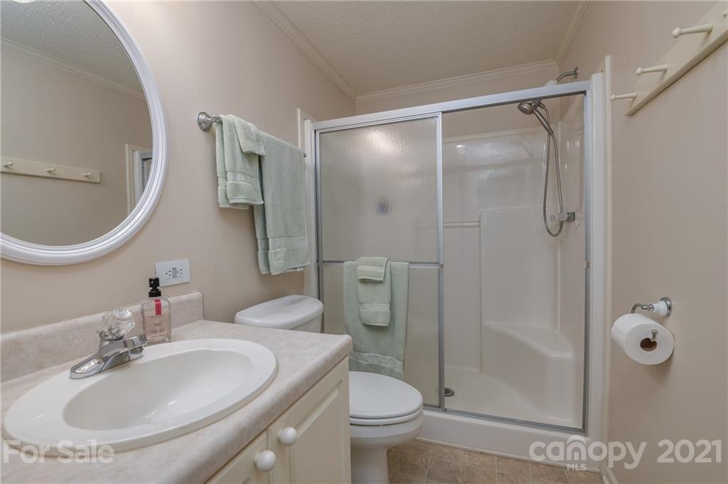 569 Flynn Road Rutherfordton, NC 28139 - Photo 25 of 34 a bathroom with a sink toilet and shower