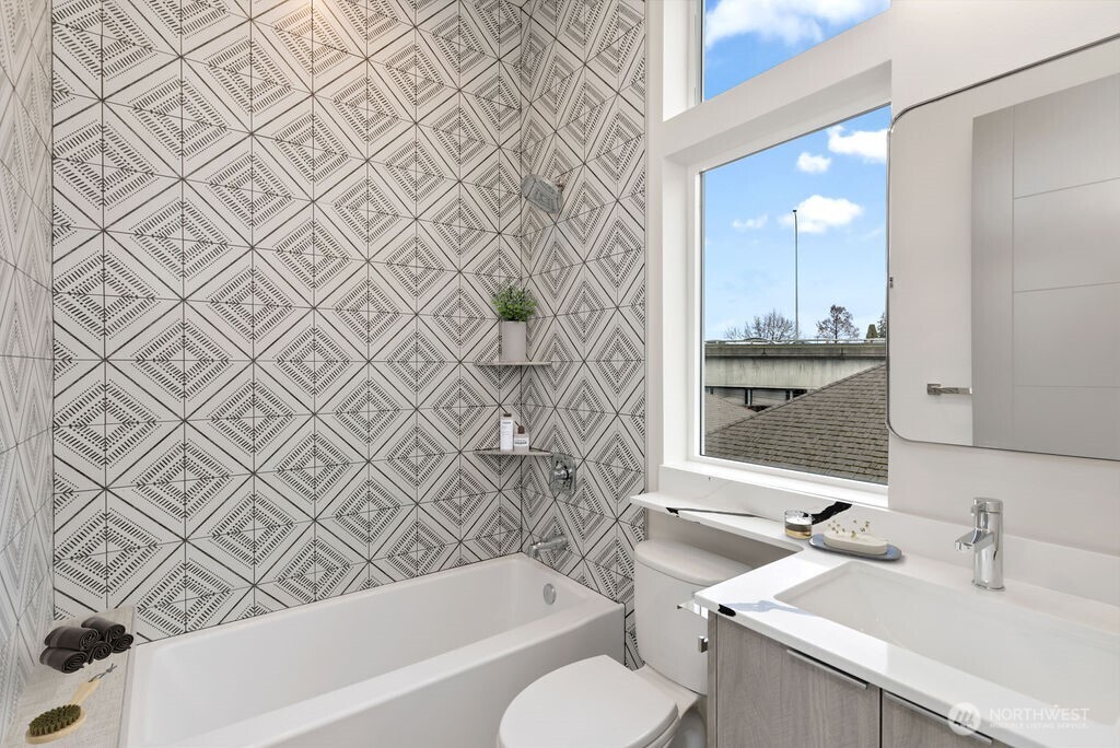 2921 Franklin Avenue East, Unit B Seattle, WA 98102 - Photo 18 of 30 a bathroom with a sink a toilet and shower