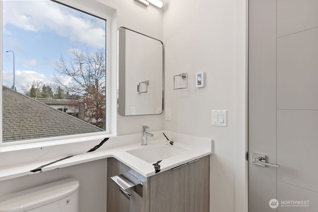 2921 Franklin Avenue East, Unit B Seattle, WA 98102 - Photo 19 of 30 a bathroom with a sink and a mirror