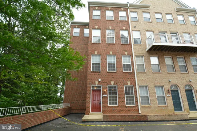 a front view of a building with a garden