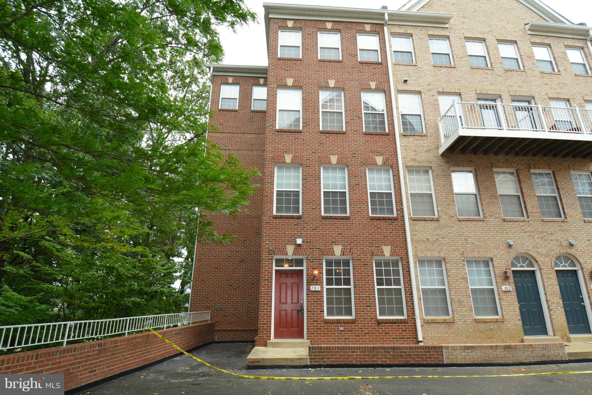 2665 Manhattan Place, Unit 101 Vienna, VA 22180 - Photo 1 of 23 a front view of a building with a garden