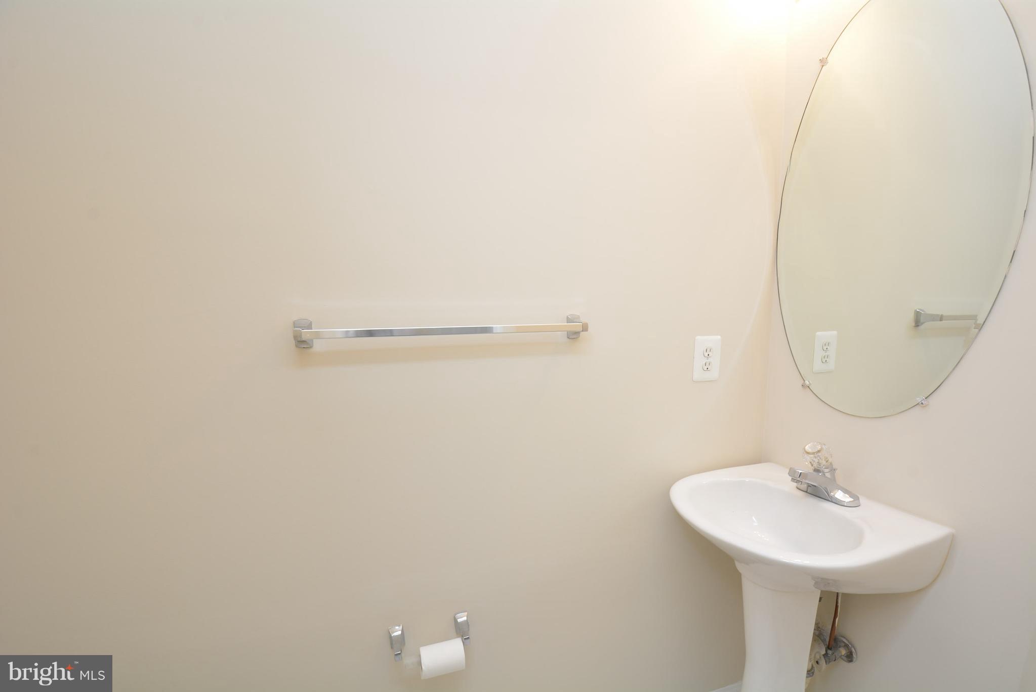 2665 Manhattan Place, Unit 101 Vienna, VA 22180 - Photo 12 of 23 a bathroom with a sink a mirror and vanity