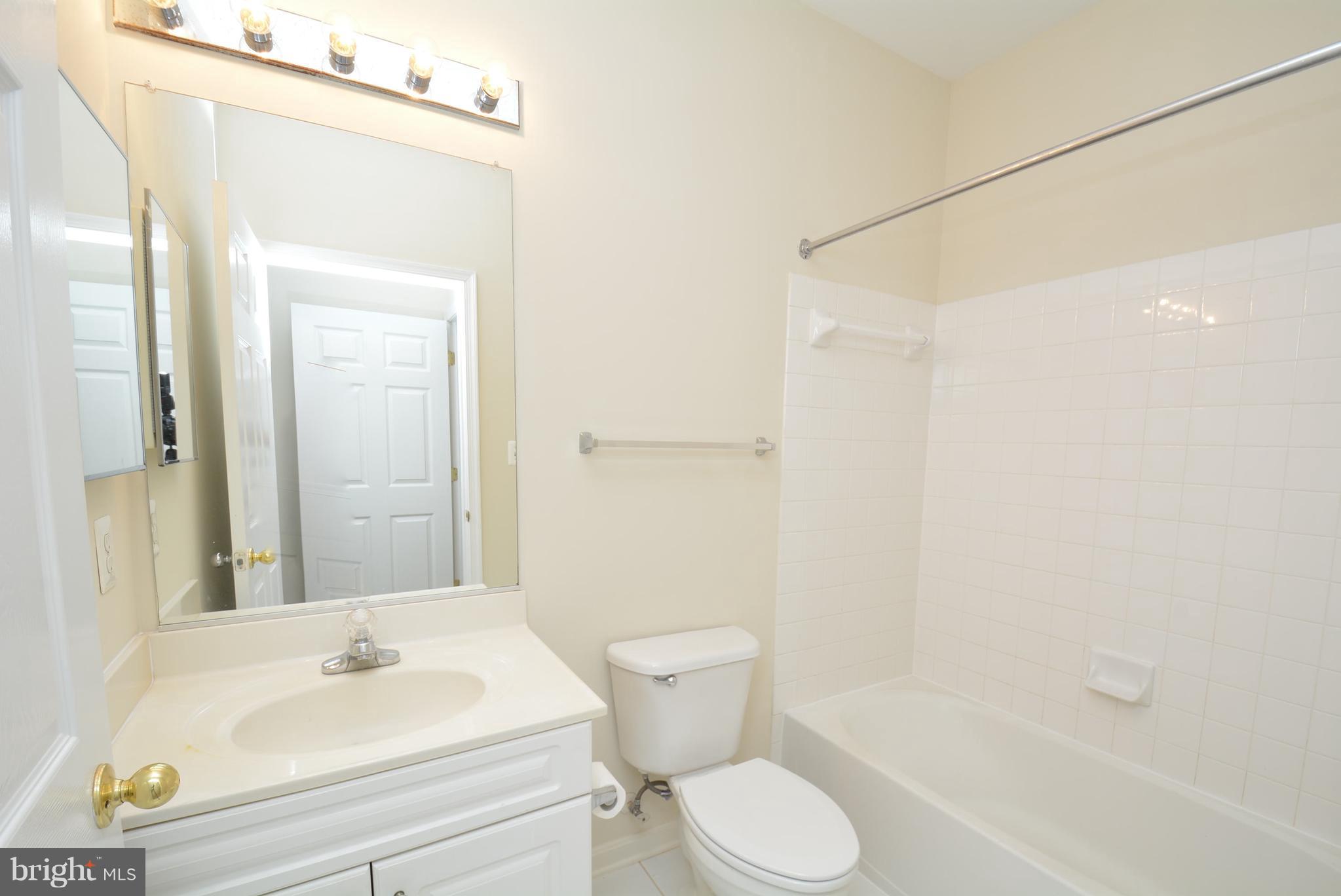 2665 Manhattan Place, Unit 101 Vienna, VA 22180 - Photo 19 of 23 a bathroom with a sink toilet and shower