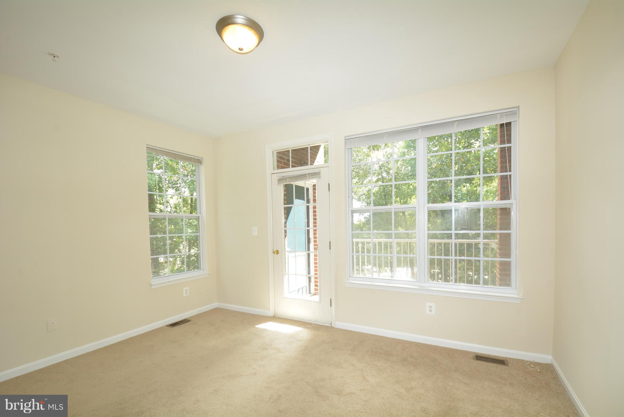 2665 Manhattan Place, Unit 101 Vienna, VA 22180 - Photo 21 of 23 an empty room with windows