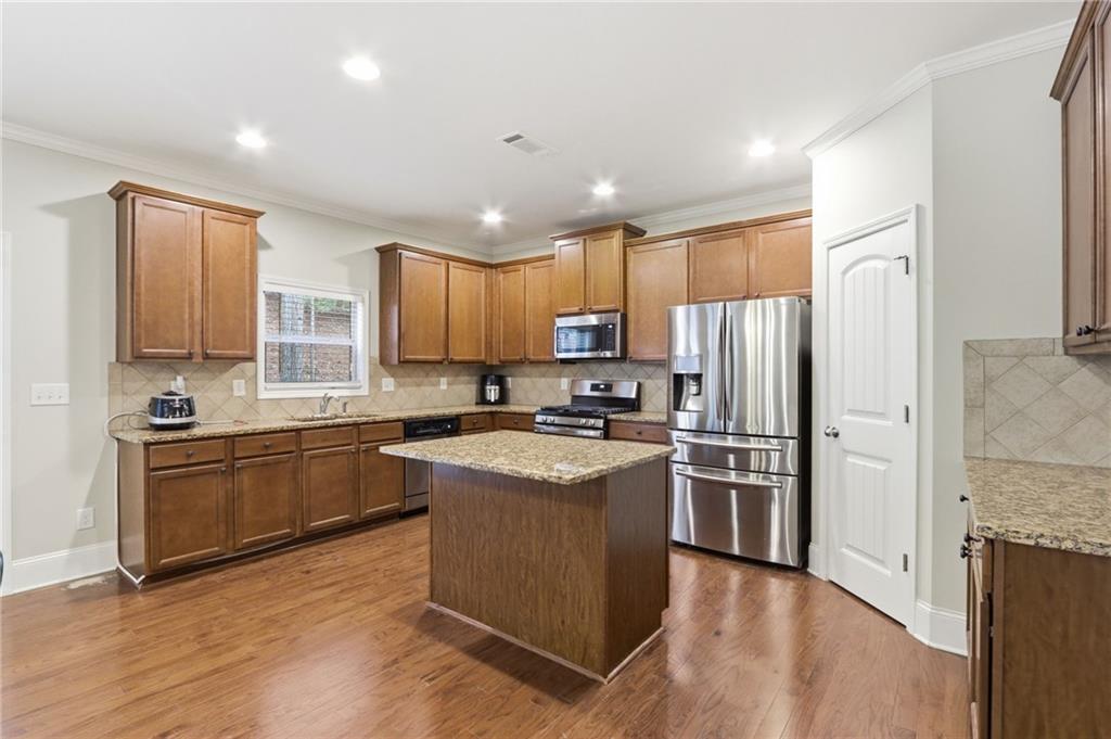1515 Riva Ridge Suwanee, GA 30024 - Photo 14 of 35 a kitchen with stainless steel appliances granite countertop a refrigerator stove and oven