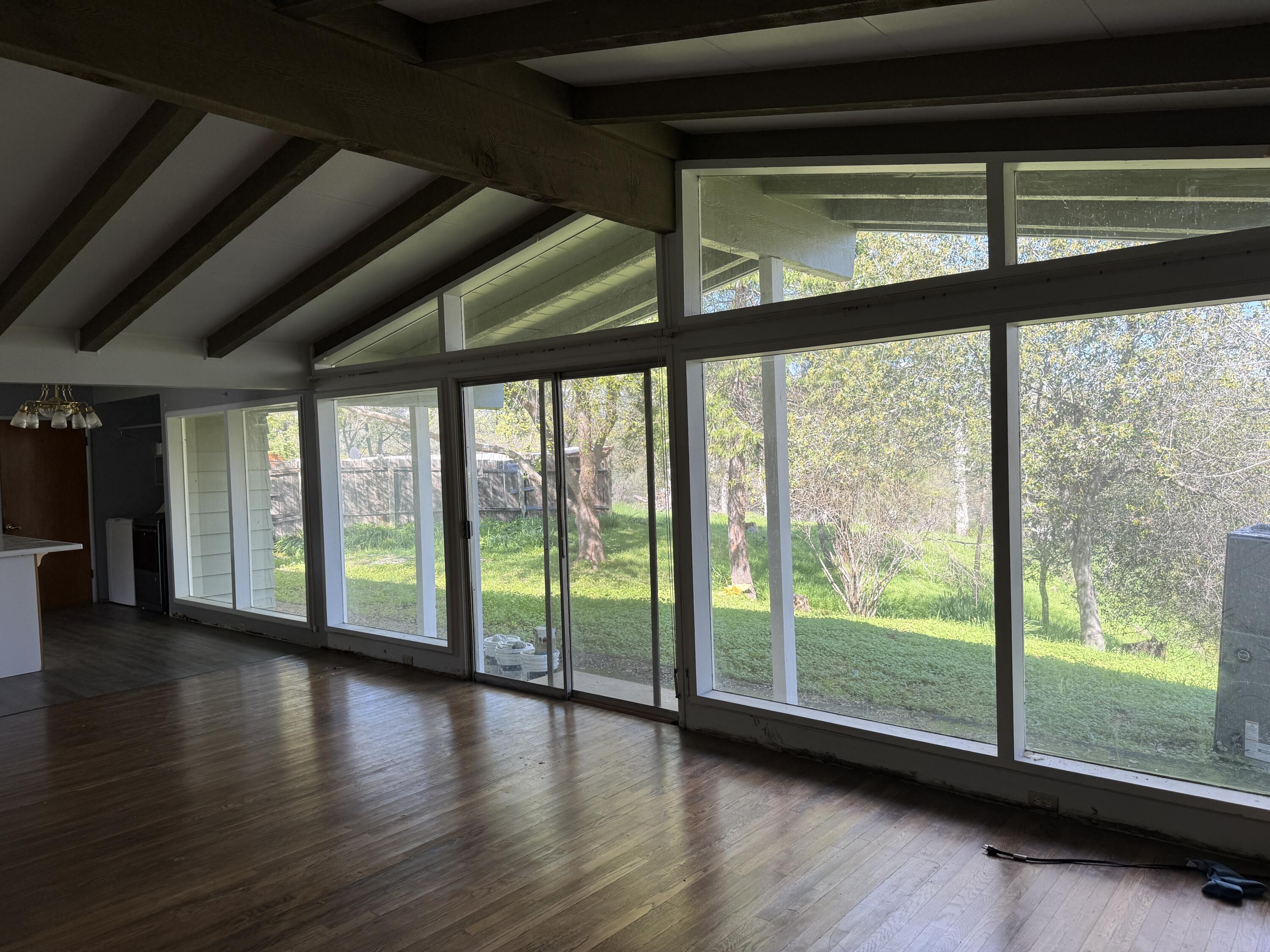 1400 Riviera Drive Redding, CA 96001 - Photo 4 of 15 a view of empty room with wooden floor and floor to ceiling window