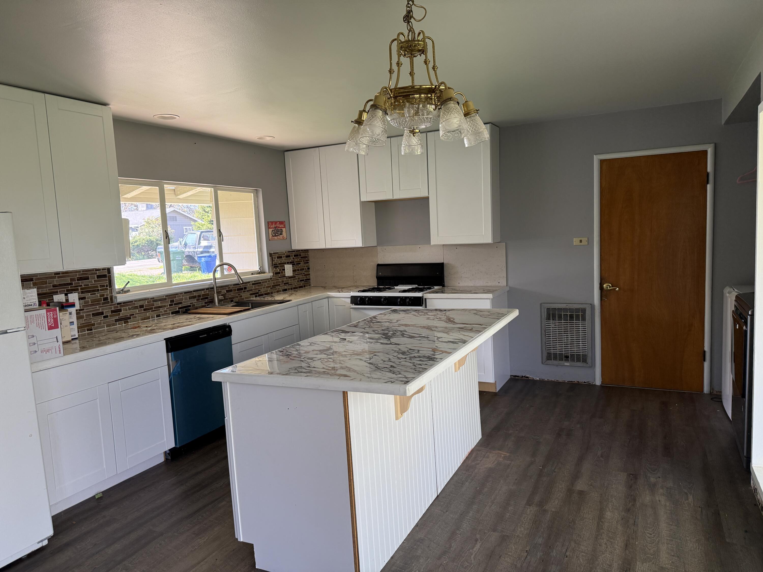1400 Riviera Drive Redding, CA 96001 - Photo 6 of 15 a kitchen with stainless steel appliances granite countertop a sink stove and refrigerator
