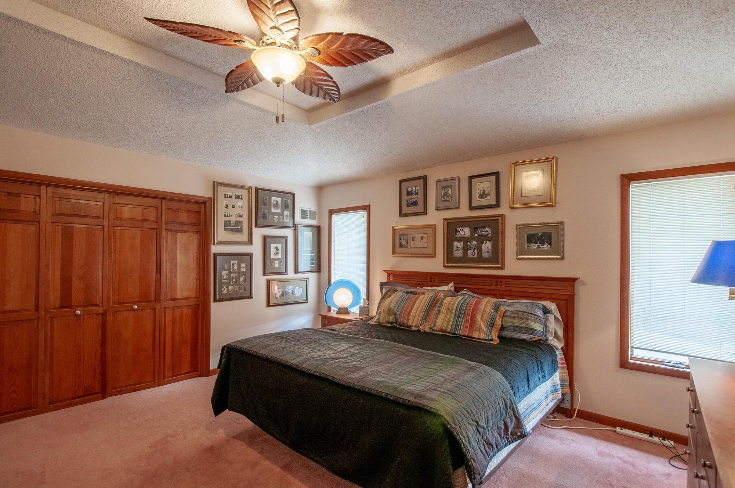 106 Merrick Lane Raphine, VA 24472 - Photo 22 of 46 a bedroom with a large bed and a chandelier