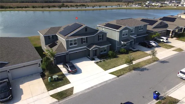 an aerial view of a house with pool and ocean view