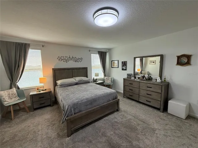 a bed room with a bed and a chair