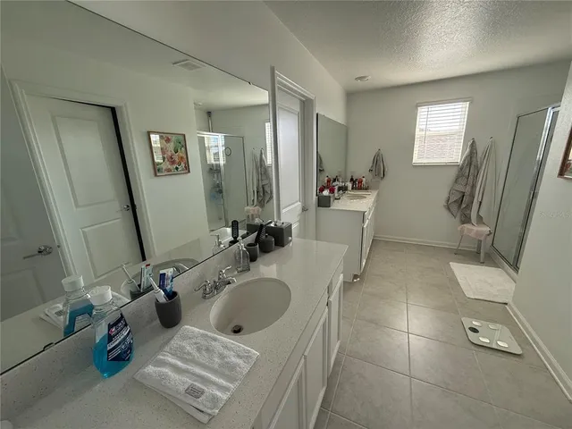 a bathroom with a tub sink and mirror