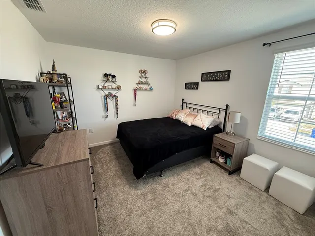 a bedroom with furniture and a window