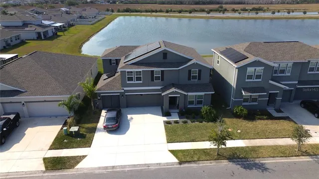 a aerial view of a house with a yard and plants