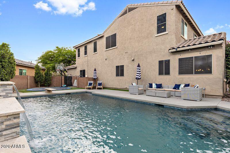 7871 South Stuart Avenue Gilbert, AZ 85298 - Photo 39 of 77 a view of a white house with swimming pool in front of it