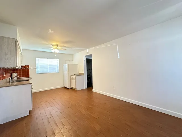a view of a kitchen with wooden floor