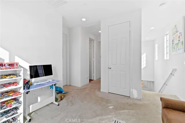 a bedroom with a bed a chandelier and a mirror