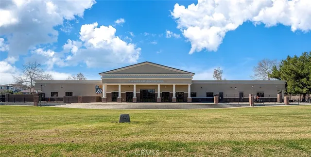 a view of a patio with dining table and chairs potted plants and palm tree