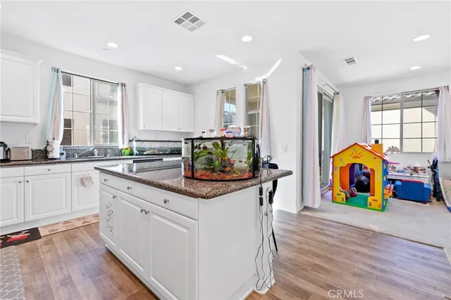 a kitchen with stainless steel appliances granite countertop a stove and cabinets