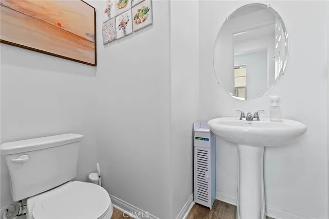 a bathroom with a sink a toilet and mirror