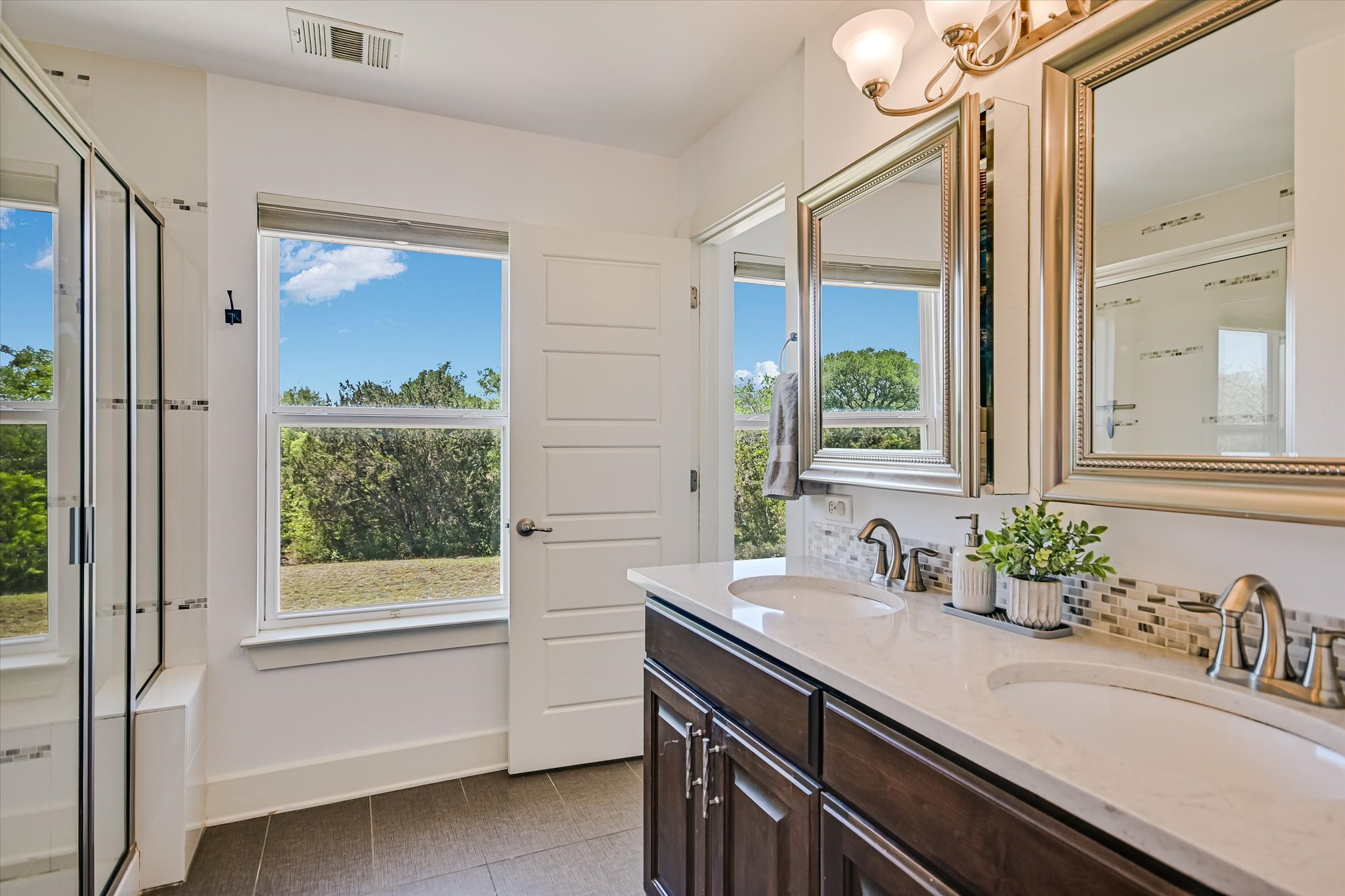 12224 Tawny Farms Road, Unit 145 Austin, TX 78748 - Photo 9 of 27 The primary bathroom features a walk-in shower, dual vanity, medicine cabinets and a spacious walk-in closet.