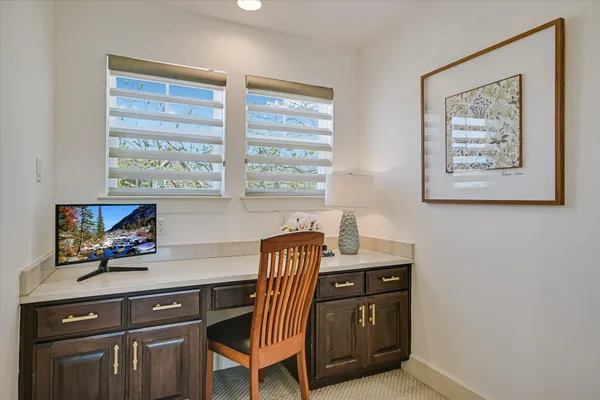 a bathroom with a granite countertop sink toilet a mirror and shower
