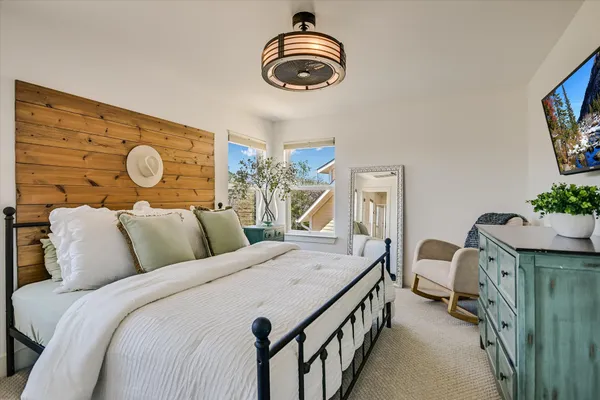 a living room with furniture a flat screen tv and a large window