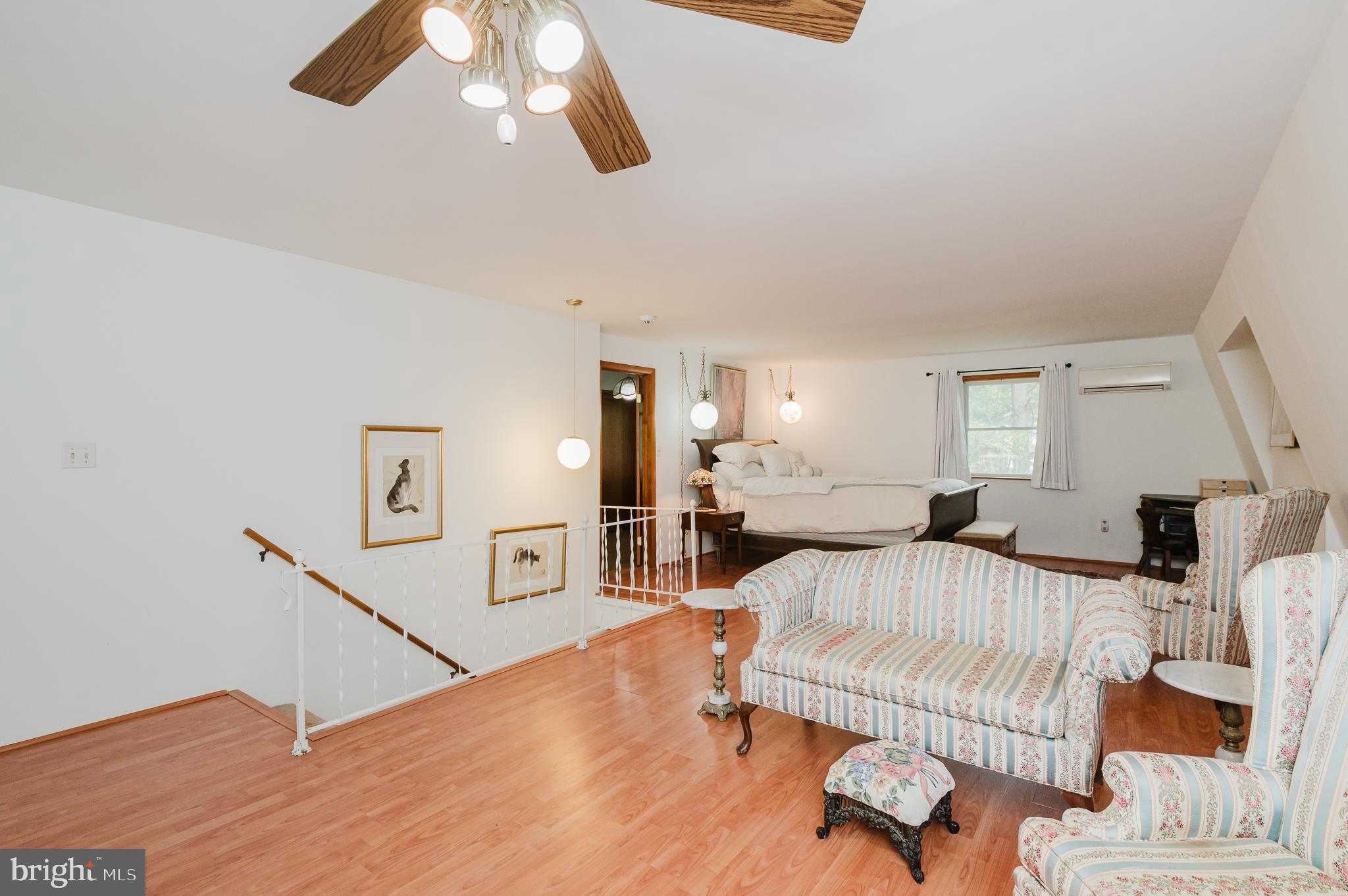 710 Magnolia Road Joppa, MD 21085 - Photo 22 of 58 a spacious bedroom with a bed and a chandelier