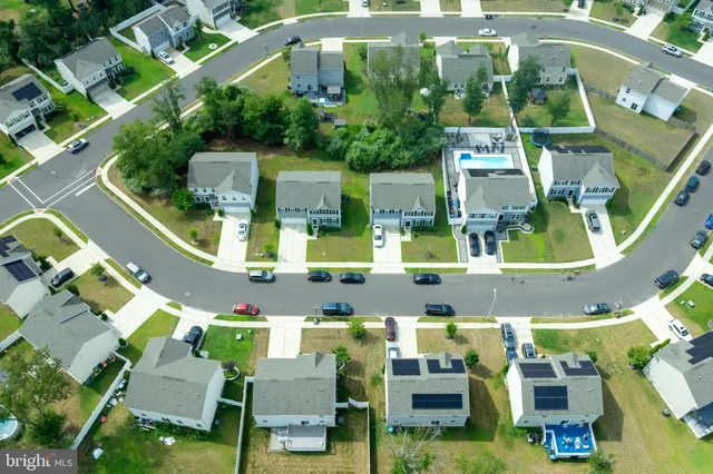 an aerial view of multiple houses with yard