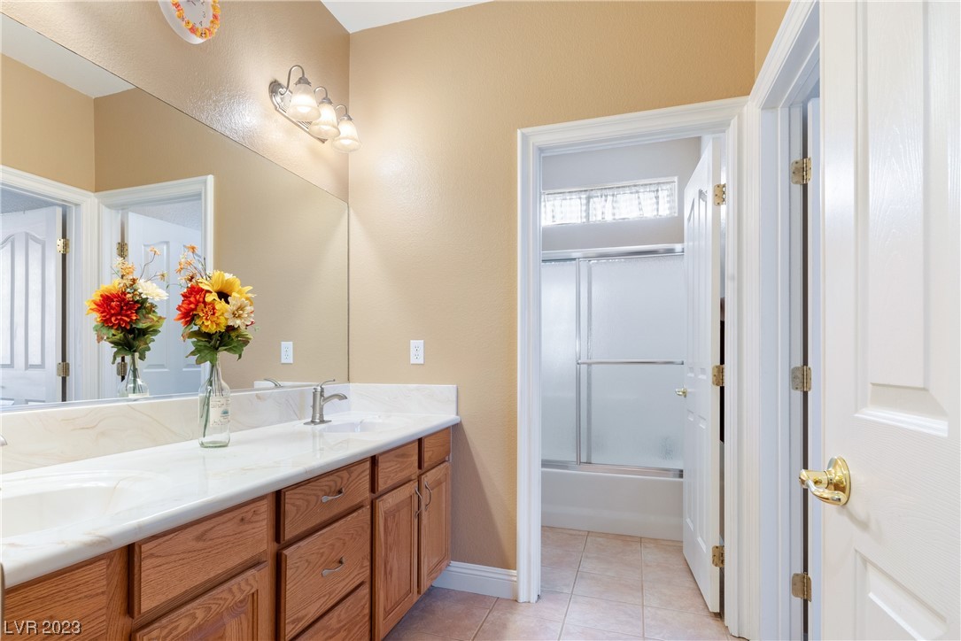 98 Milicity Road Henderson, NV 89012 - Photo 18 of 26 Upstairs, this full bathroom includes dual vanitie