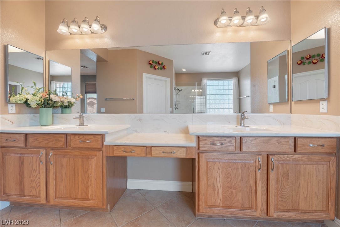 98 Milicity Road Henderson, NV 89012 - Photo 7 of 26 This primary bathroom features a dual-sink vanity
