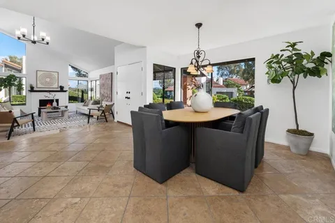 a living room with furniture a window and a chandelier