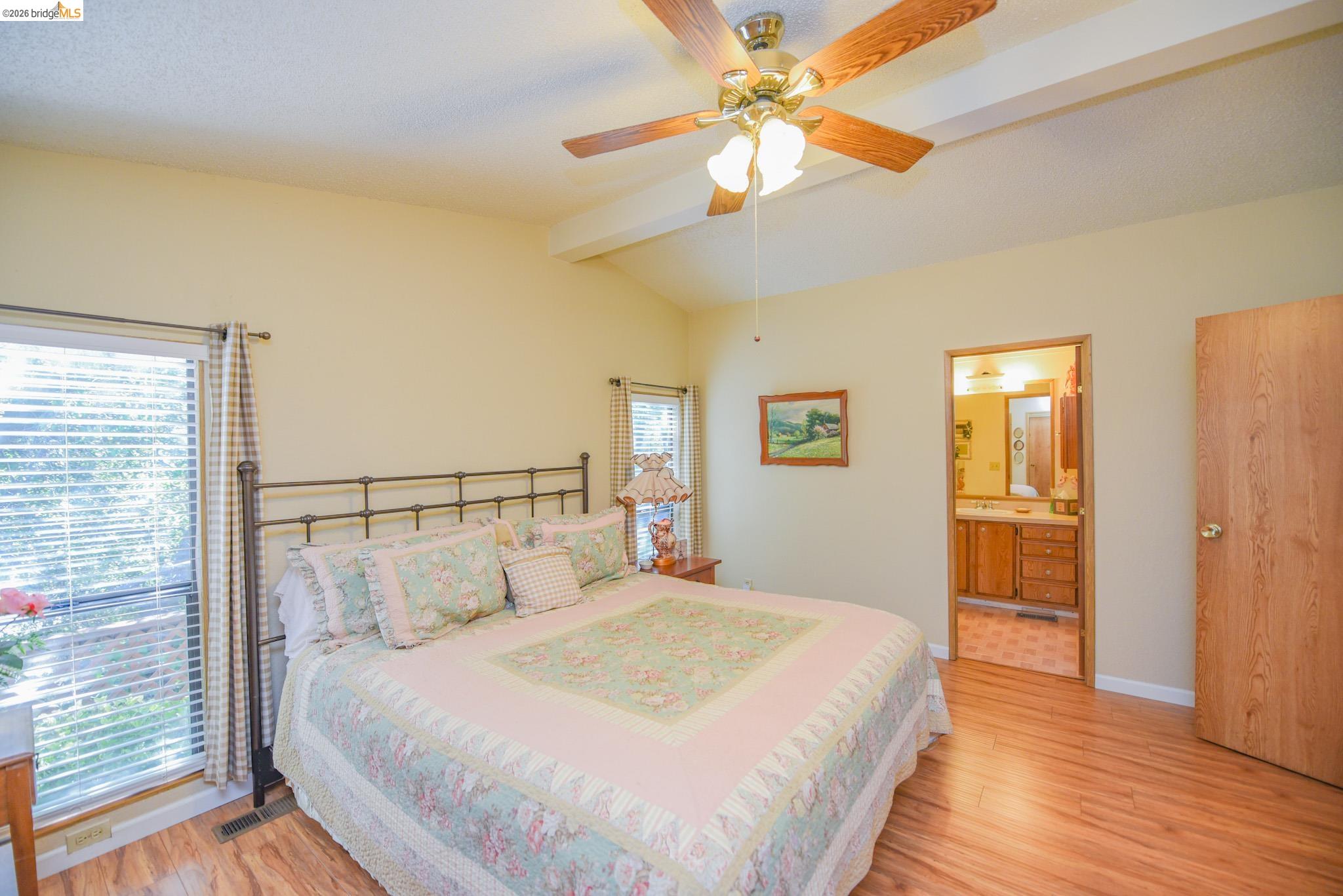 18717 Mill Villa Road, Unit 235 Jamestown, CA 95327 - Photo 14 of 26 Bedroom featuring light wood finished floors, ensuite bath, and ceiling fan