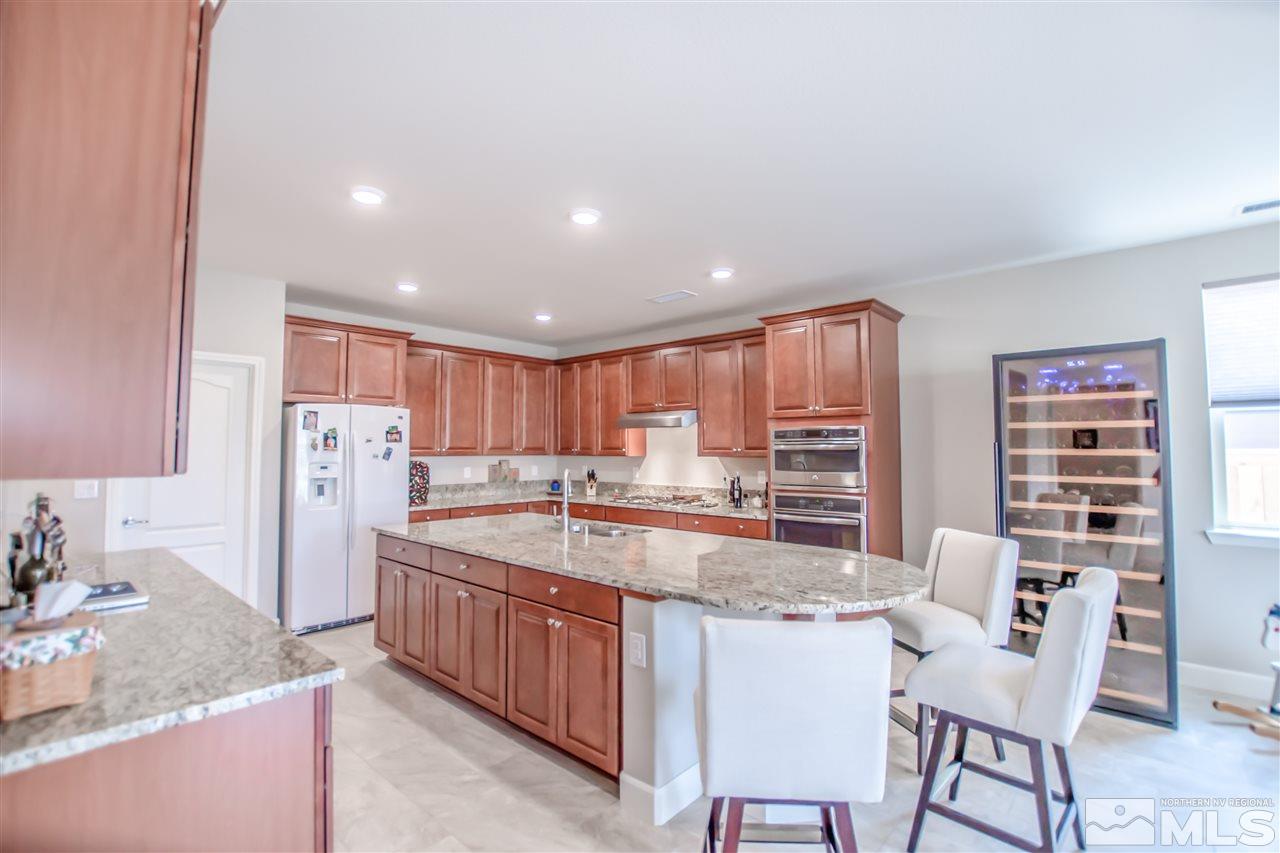 1705 Scott Valley Road Reno, NV 89523 - Photo 3 of 16 a kitchen with refrigerator and chairs