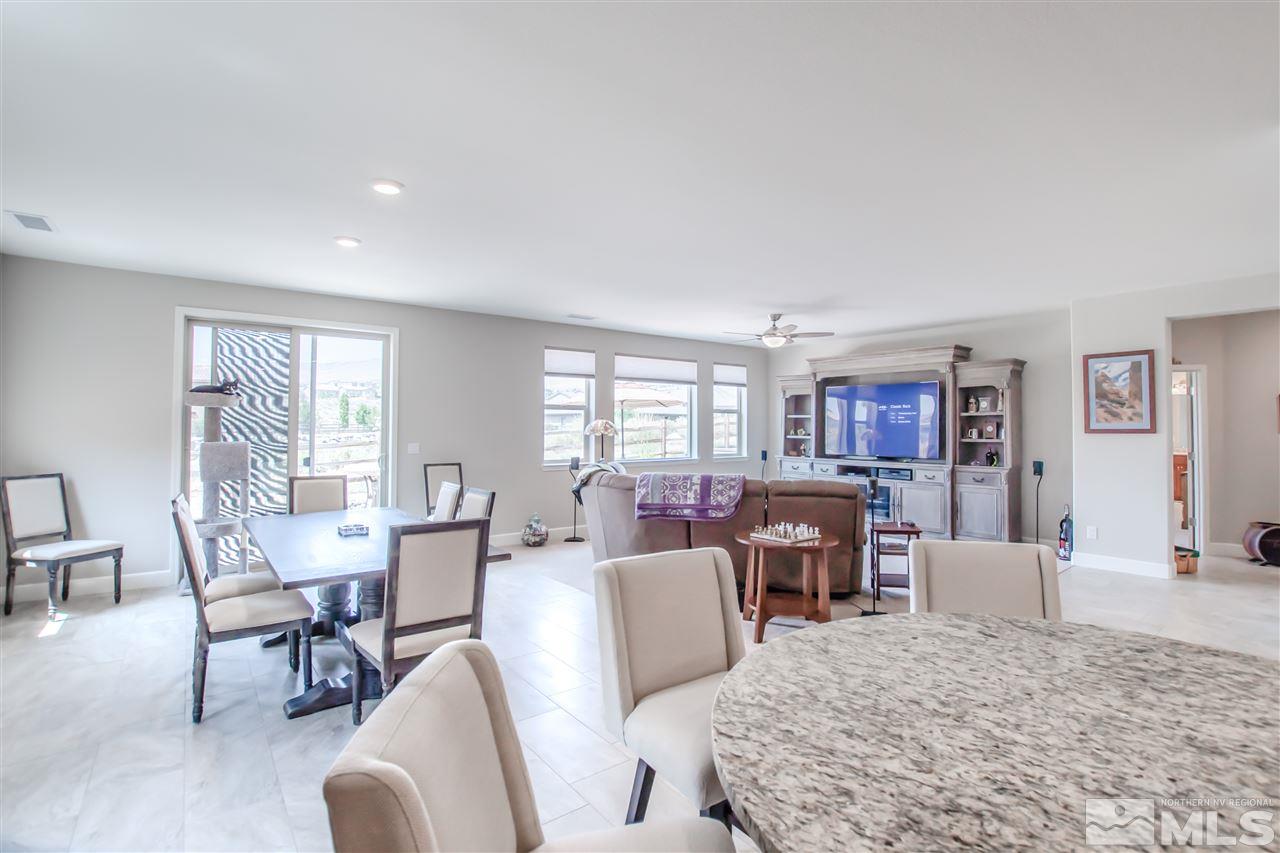 1705 Scott Valley Road Reno, NV 89523 - Photo 6 of 16 a living room with furniture a large window and a dining table