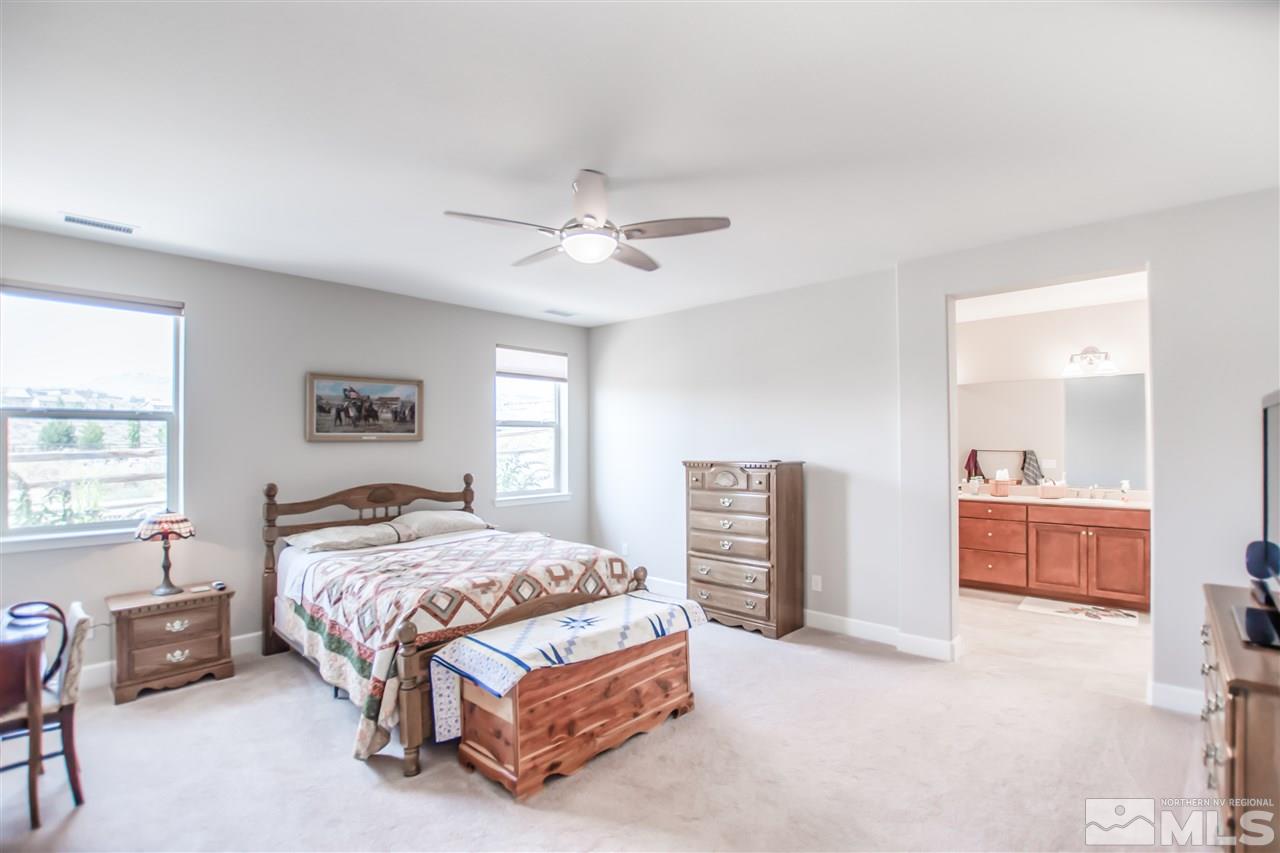 1705 Scott Valley Road Reno, NV 89523 - Photo 9 of 16 a bedroom with a bed and a chandelier