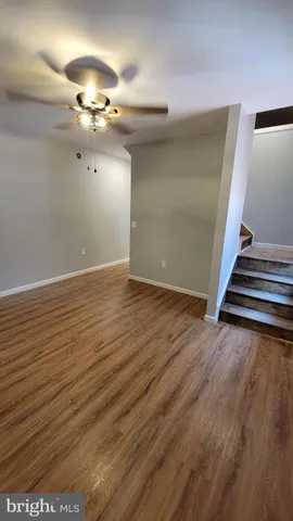 wooden floor in an empty room with stairs