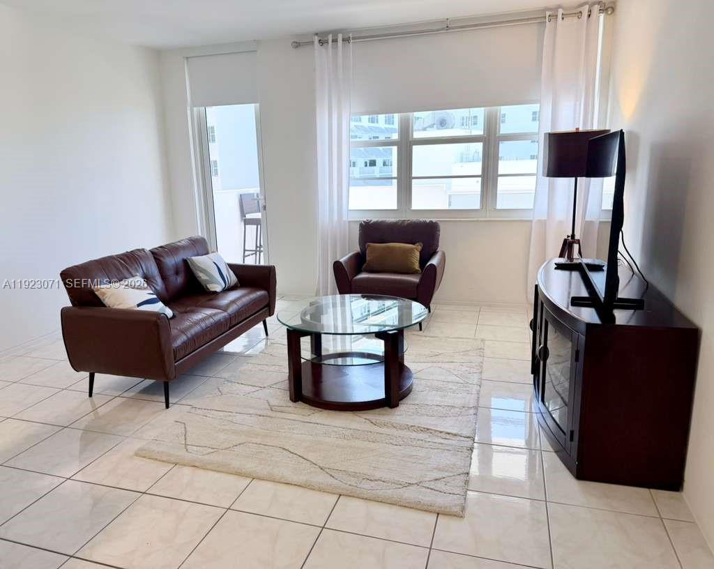 100 Lincoln Road, Unit 541 Miami Beach, FL 33139 - Photo 8 of 17 a living room with furniture and a window