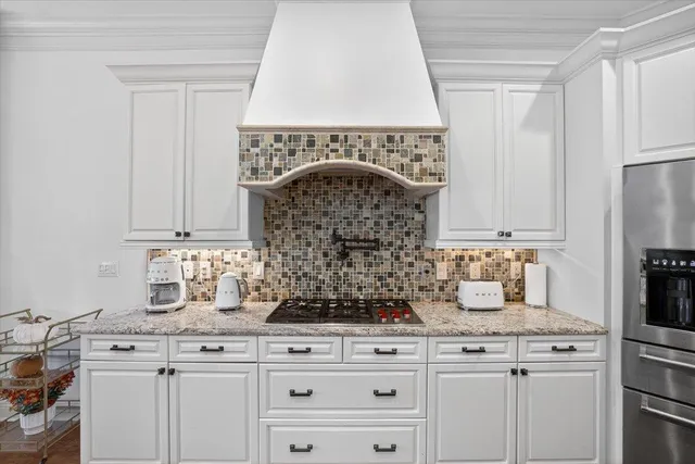 a bathroom with a granite countertop sink a toilet and shower