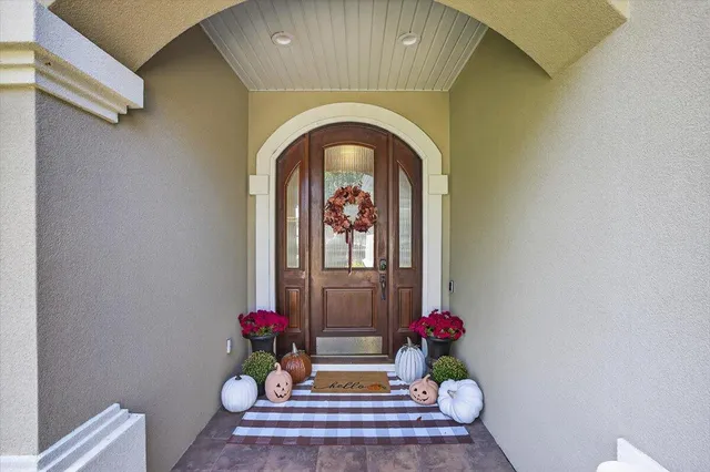 a view of a dining room with furniture a chandelier and wooden floor